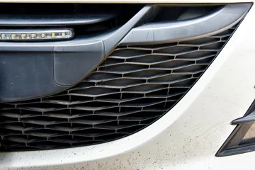Deurstickers close up of grid car lattice on front bumper © Jiggo_Putter