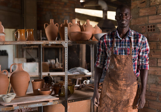 Portrait Of Professional African American Male Potter Standing In Pottery Workshop