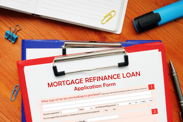 Business concept meaning MORTGAGE REFINANCE LOAN Application Form with sign on business paper in...