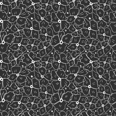 Seamless flowers with white outline on a black background.