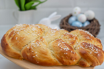 Sweet home made braided yeast bun for easter on a table
