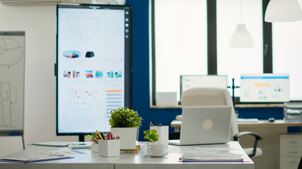 Interior of empty creative office, new financial business, start up company with no people in it. Company with modern design and conference table ready for brainstorming with nobody in room