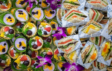 Fototapeta na wymiar Whole wheat bread sandwich with eggs, crab sticks and salad greens with mixed fruit cookies. Thai snacks. Concept of healthy eating, healthy lifestyle.