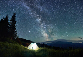 View of night mountain landscape with Milky Way galaxy.