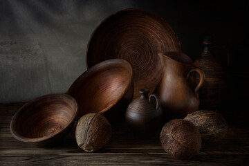 Nuts in an earthenware dish on a wooden table.