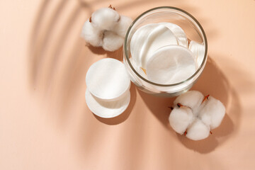 Cotton discs for skincare in a jar on paper background