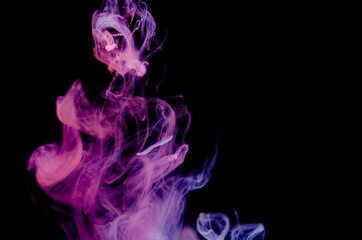 Ink swirls underwater. Ink cloud isolated on black background. Abstract effect of explosion of cosmos universe smoke with particles.