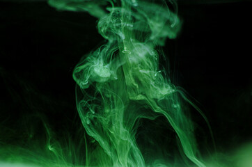 Ink swirls underwater. Ink cloud isolated on black background. Abstract effect of explosion of cosmos universe smoke with particles.