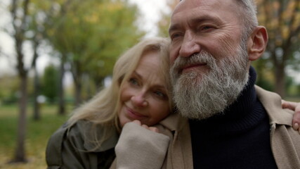 Fototapeta premium Portrait of loving beautiful senior couple enjoying each other outside. 
