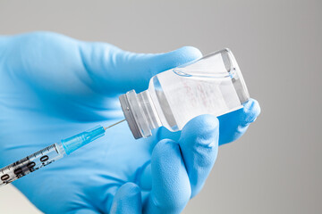 Close up isolated concept image for a healthcare professional sucking liquid medication or vaccine...