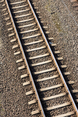 Rusty railroad tracks on gravel. Top view of railways on a sunny day