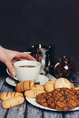 sweet biscuits on a plate a cup with a drink candy Dessert snack