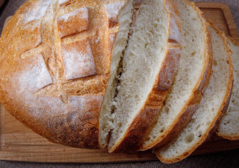 A sliced loaf of white bread on a cutting board .Art bread.