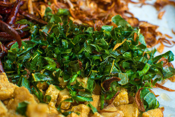 Cooking components of Thai food. Chili, garlic, onion, kaffir lime leaves, pork crackling, fried.