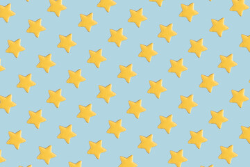 Creative pattern with yellow gingerbread stars  on blue background.. Sweet minimal concept