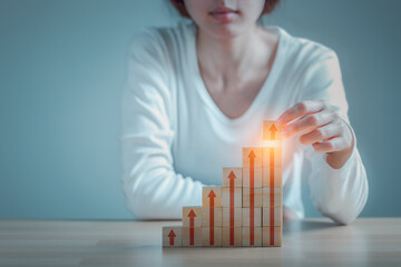 Woman hand arranging wood block stacking as step stair growth success process on wooden table background, Business organization startup concept.