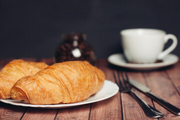crispy croissants on a plate kitchen utensils for breakfast 