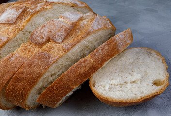 Round white bread on the concrete surface. Fresh bread.