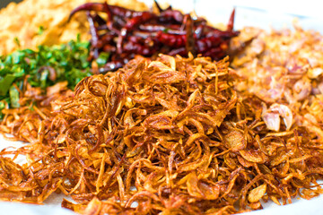 Cooking components of Thai food. Chili, garlic, onion, kaffir lime leaves, pork crackling, fried.