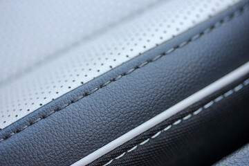 Close up of a white and black leather seat