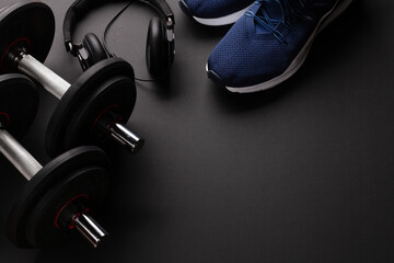 Fototapeta na wymiar Sneakers, headphones and dumbbells. Sport, fitness and healthy lifestyle