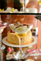 Dessert stand in cafe. Glass stand with different cakes and desserts, sweet food. Eating out concept