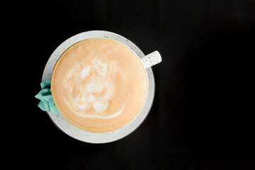 Cup of americano coffee with milk over black background. Coffee time, isolated on black.
