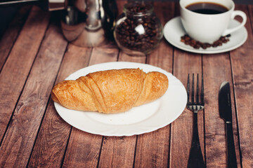 crispy fresh croissants on a plate on the table breakfast dessert