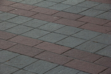 Red and gray tiles on the sidewalk