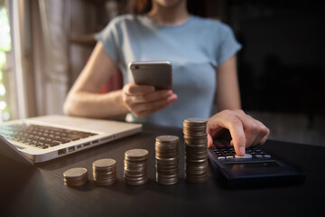Business women are calculating daily expenses in the office.