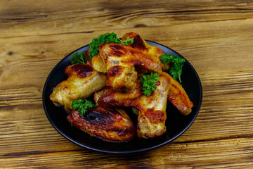 Baked chicken wings on a wooden table