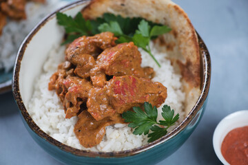Close-up of indian butter chicken or Murgh Makhani in a bowl, selective focus, studio shot