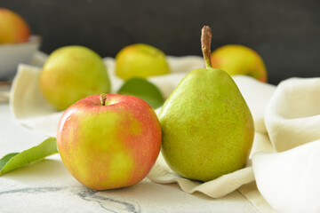 Tasty apple and pear fruits on table