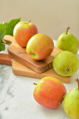 Tasty apple and pear fruits on table
