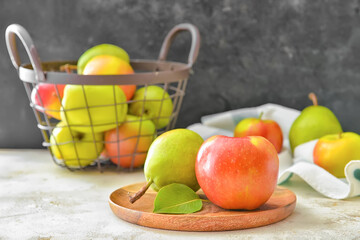 Plate with tasty apple and pear fruits on table