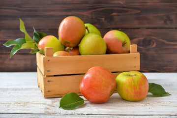 Box with tasty apple and pear fruits on table