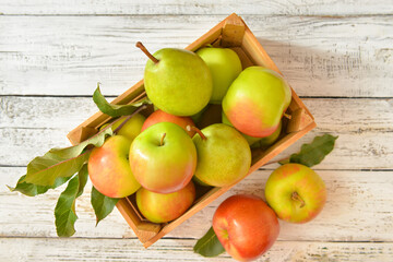 Box with tasty apple and pear fruits on table