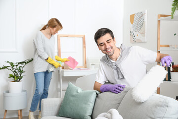 Fototapeta premium Young couple cleaning their flat