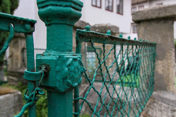 old green iron fence in retro style