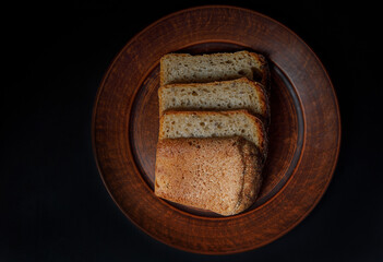 Sliced pieces of bread close-up on a ceramic plate. Sourdough bread.