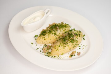 Potato zeppelins with sour cream on a white background © Евгений Бордовский