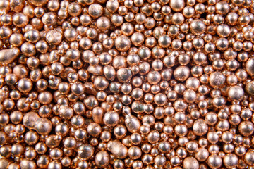 Background from many shiny metal balls. Gold background.