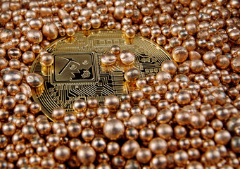 The physical gold bitcoin (reverse side) is partially covered with gold balls.