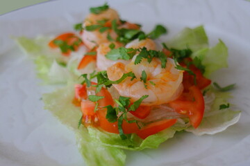 Spring rolls with prawns, tomatos and salad in the preparation