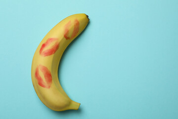 Banana with kiss marks on blue background