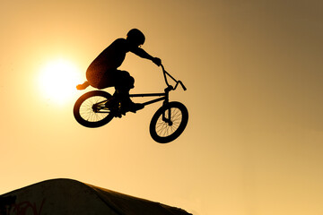 silhouette of a biker in the air