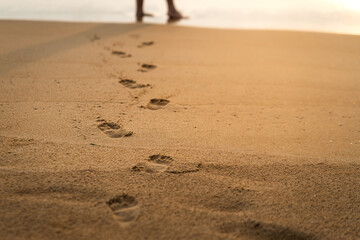 Human's footprint mark on sand beach. Travel and relaxation concept background photo. Selective soft focus at footprint part.