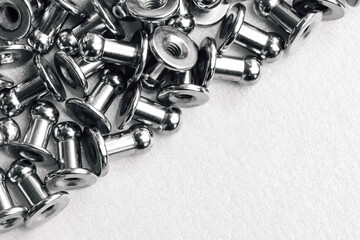 macro black and white background of sewing accessories-grommet, rivet, snap, button and half...