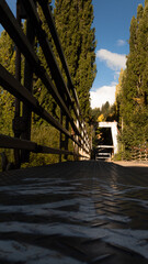 Beam metal suspension bridge on a sunny day in autumn.