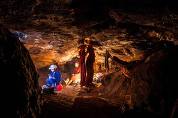 Speleologists resting in underground camp in a cave